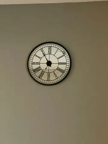 Round decorative wall clock with Roman numerals - black frame