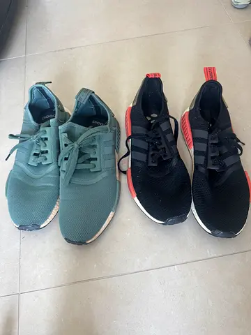 Two pairs of Adidas NMD-style sneakers - black/red and green, used
