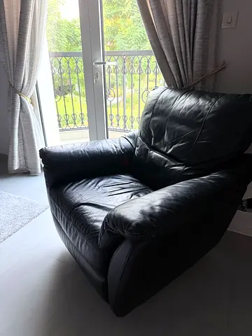 Black leather recliner armchair with footrest - good condition