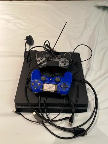 PlayStation 4 Slim with 2 Controllers and Cables - Good Condition