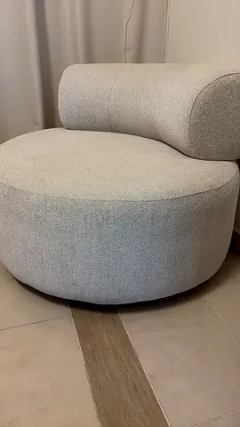 Light grey curved lounge chair - modern pouf-style seat