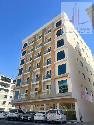 Two-bedroom apartment with a living room, two bathrooms, and a balcony in Al-Jarf 3 area, new building, families only, very prime location