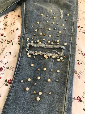 Light blue distressed jeans with pearl and stud embellishments - size approx. M