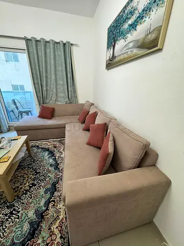 Light beige L-shaped sofa with chaise, good condition