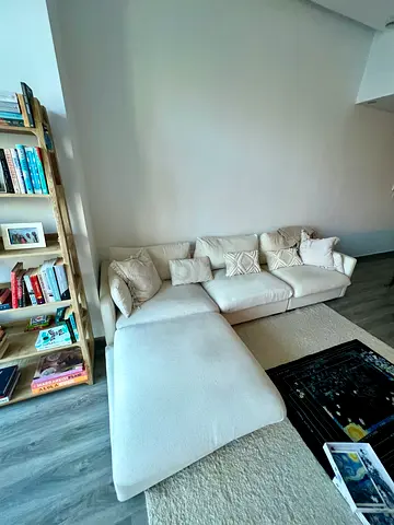 Light beige L-shaped fabric sofa with chaise lounge — well maintained