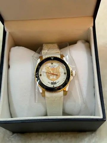 Gucci white silicone strap watch with gold-tone bezel — unworn in box