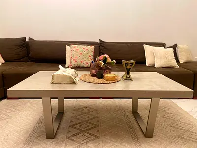 Modern rectangular coffee table with concrete-look top and metal legs