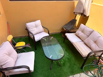 4-piece outdoor patio seating set with cushions and glass coffee table