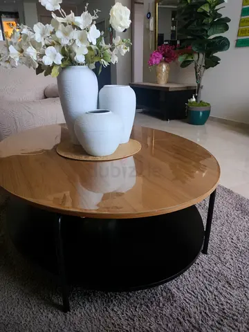 Round wooden coffee table with lower shelf