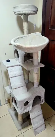 Multi-level beige cat tree with condos and scratching posts