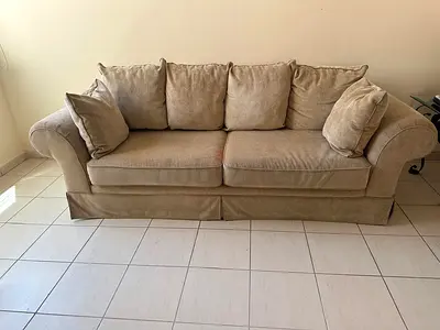 Comfortable beige 3-seater sofa with matching pillows