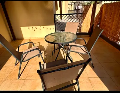 Outdoor patio dining set - glass top table with 4 sling chairs