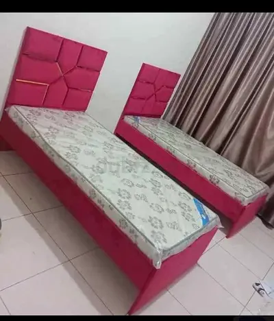 Pair of single beds with mattresses - pink upholstered headboards