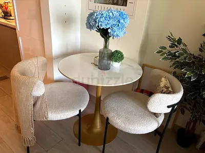 Modern round pedestal dining table with two chairs