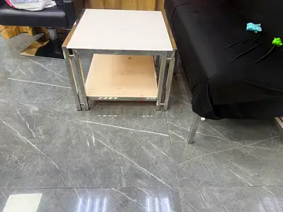 Simple metal frame side table with lower shelf.