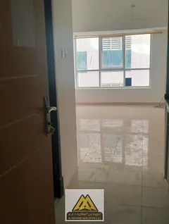 Ajman. The studio features a semi-separated kitchen, central air conditioning, and free maintenance,