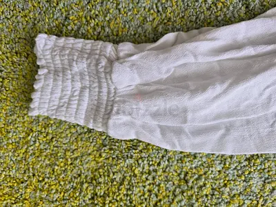 White long-sleeve top with smocked cuffs — gently used
