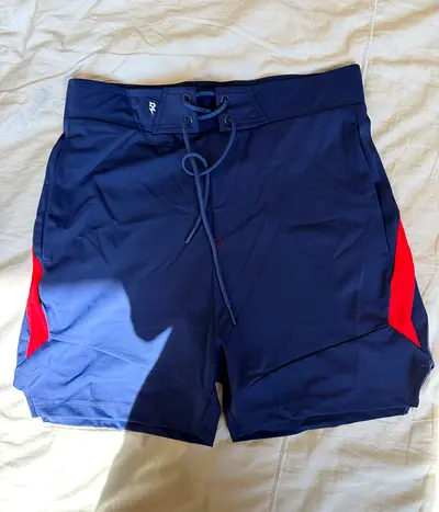 Navy blue mens swim shorts / board shorts with red side panels - size M
