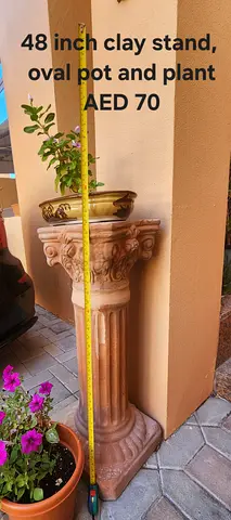 48-inch decorative clay pedestal stand with oval planter and plant