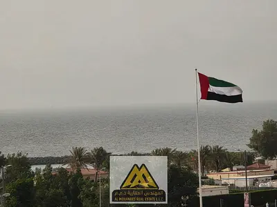 near Al Diwan Towers: A spacious two-bedroom apartment with a living room and a marina view.