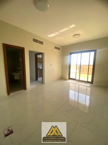 A one-bedroom apartment for annual rent in Al Rawda 1, Ajman, featuring a master bedroom, balcony, central AC, free maintenance, and a prime location