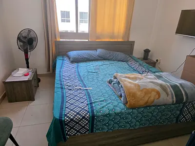 Queen-sized bed frame with mattress and bedding - good condition