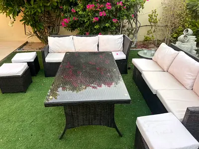 Outdoor rattan garden sofa set with glass-top dining table and cushions