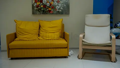 Used mustard yellow 2-seater sofa with matching cushions + wooden lounge chair