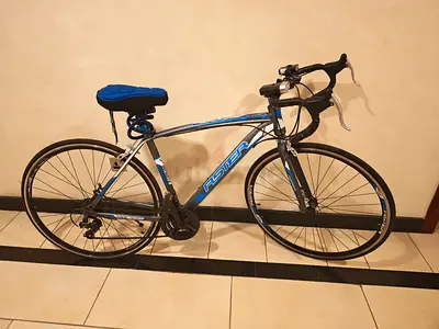 Used road bike - alloy frame with drop handlebars,