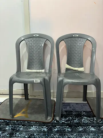 Pair of grey plastic chairs
