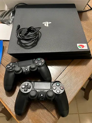 PlayStation 4 Pro with 2 DualShock 4 Controllers - Good Condition