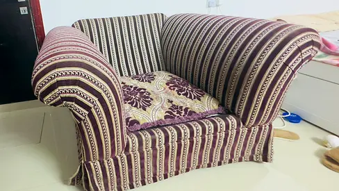 Large single-seater upholstered armchair in striped fabric
