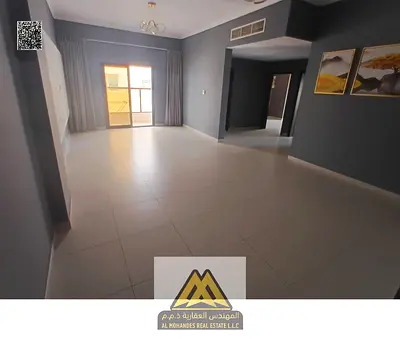 For rent: 2-bedroom apartment with hall in Al Rawda 2. Spacious layout, balcony, 2 bathrooms, central AC, free maintenance, prime location. AED 39,000