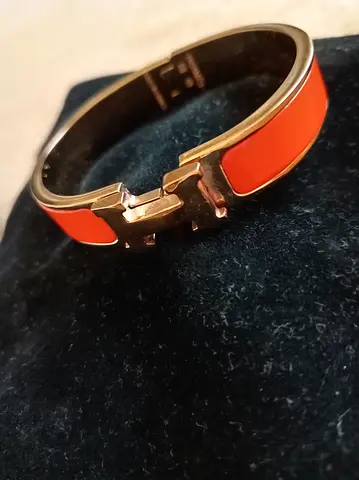Gold-tone orange enamel bangle bracelet (H-style clasp)