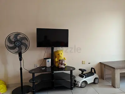 32-inch Flat Panel TV on Stand with Accessories (Good Working Condition)