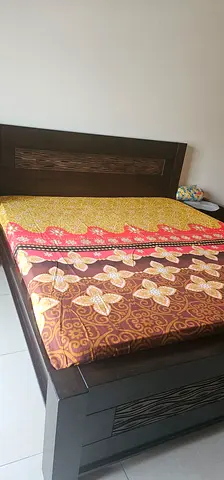 Wooden bed with mattress