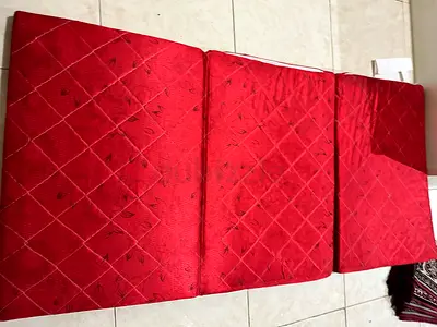 Red foldable floor mattress / futon - three panels, good condition