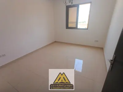 One-bedroom apartment with living room in Al Alia, Ajman. 2 bathrooms, central AC, large space, family building. Prime location on Sharjah/Dubai exit.