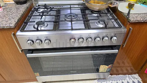 Used stainless steel 5-burner gas cooker with oven