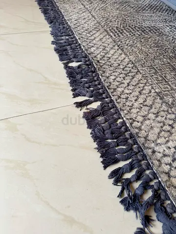 Blue patterned area rug with fringe — good condition