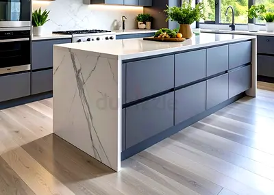 Modern kitchen island with grey cabinets and marble-effect ends