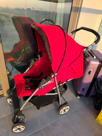 Red lightweight standard baby stroller in good condition