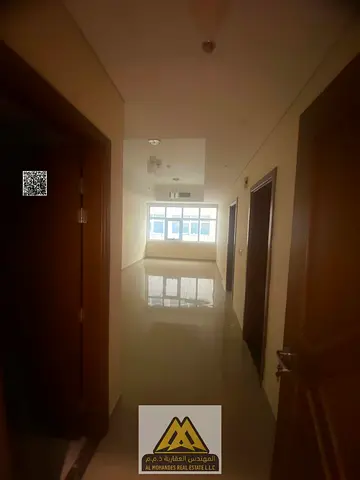 For rent in Ajman Industrial 2: spacious 1BR apartment, prime main road location, 38k AED, 4 payments.