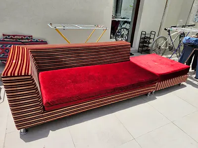Long striped red sofa cum bed / low lounge with removable cushions
