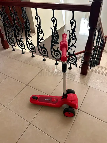 Red three-wheeled kids scooter - good condition
