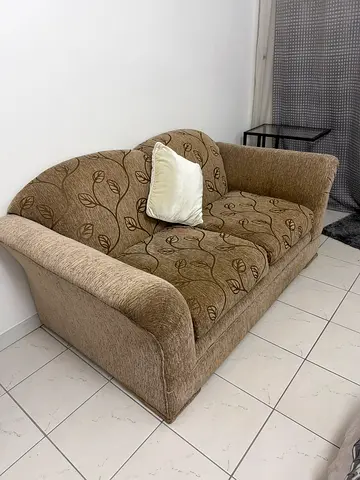2-seater beige patterned sofa in good condition
