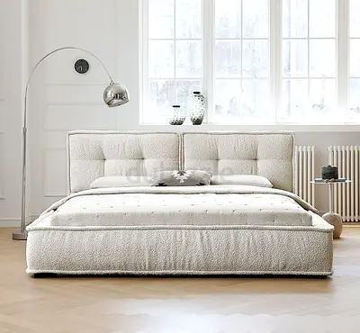 Light cream upholstered double bed with padded headboard