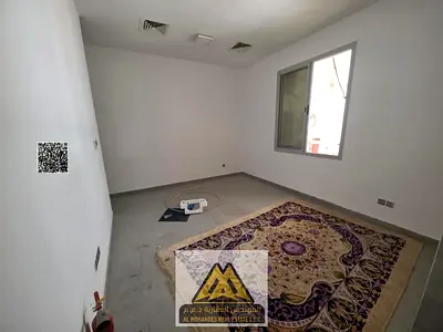 Studio in Al Rawda 1 ground floor semi-separate kitchen central AC new building AED 18K yearly 4 payments prime location free maintenance close to ser