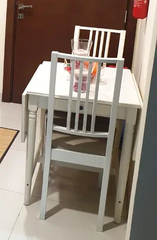 Extendable Compact white dining table with two matching chairs - good condition