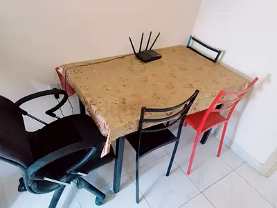 Used dining table with 4 mixed chairs — compact set